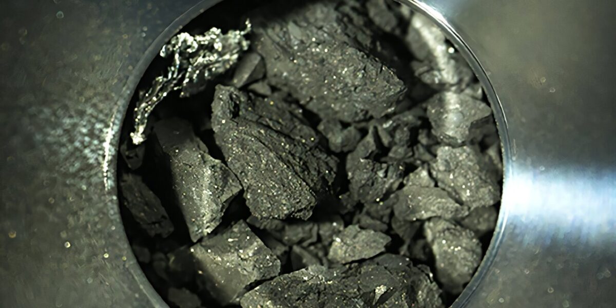 The black particles from an asteroid some 300 million kilometers away look unremarkable, but they hold components of life.